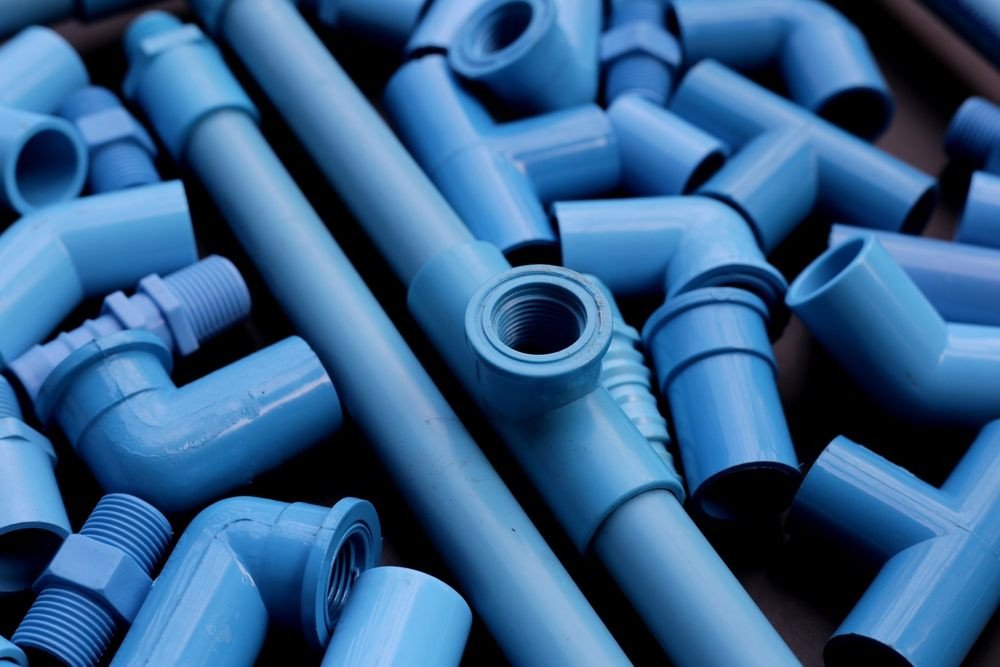 What Causes Poly B Piping to Degrade Over Time in Calgary Properties? Plumber equipment with blue pvc pipe connections for plumbing work.