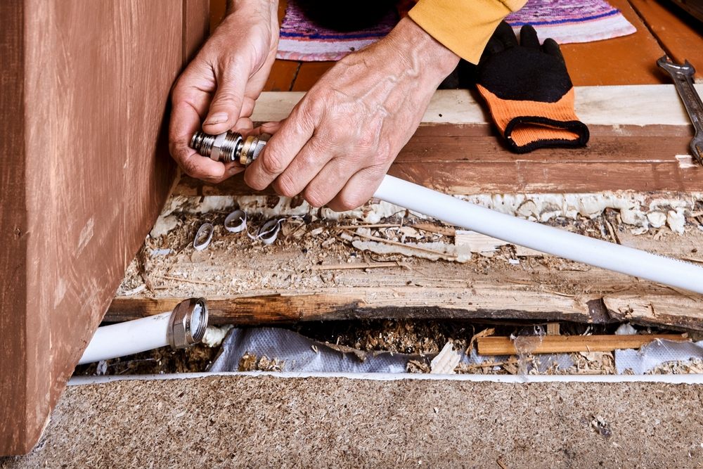 Understanding Poly B Plumbing: Risks & Repair Options in Calgary. Professional replacing aging Poly B Pipe. 